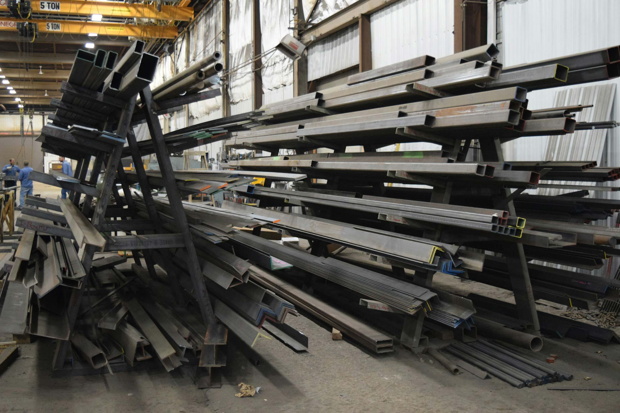 a large pile of steel beams in a warehouse Organised and secure pipe storage solutions Northern Ireland Dublin